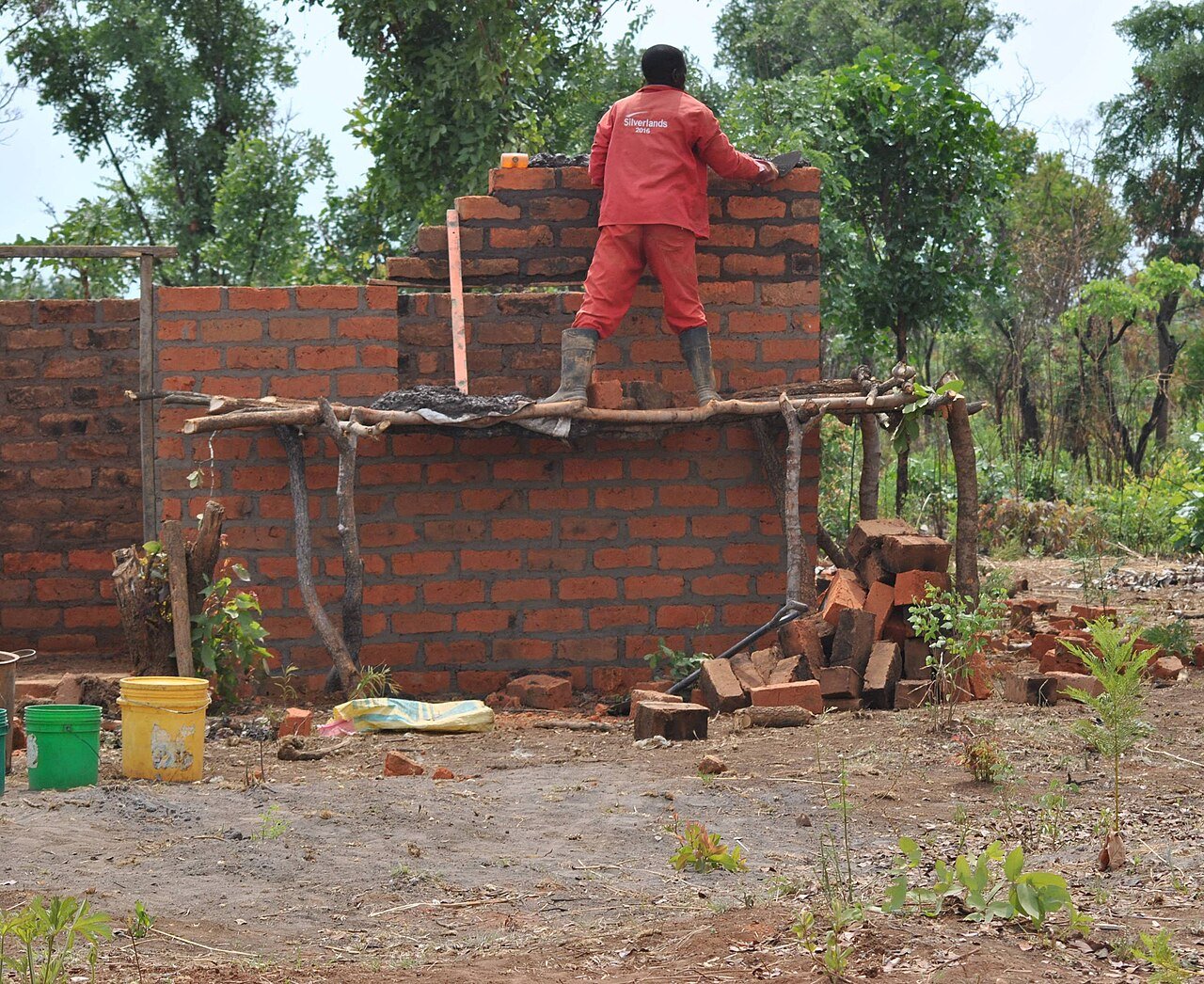 Bricklayer building a brick wall on site