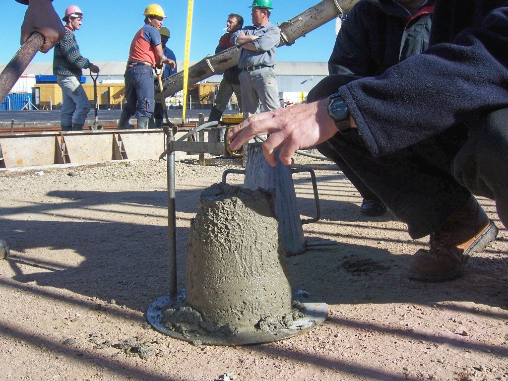 Concrete slump test being carried out on site with a steel slump cone