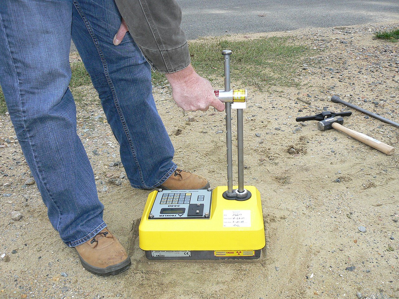 Nuclear moisture-density gauge being used to test soil on site