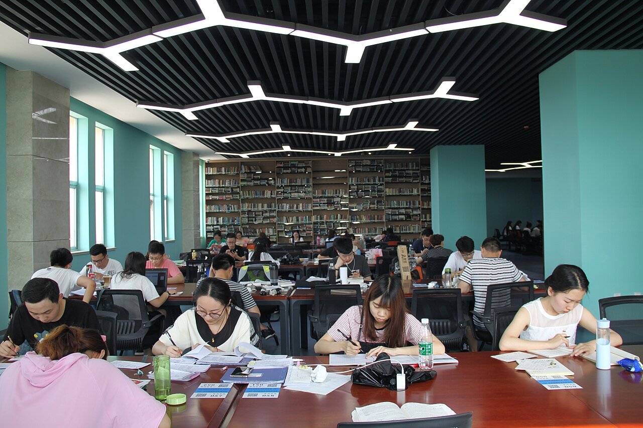 Students studying at desks in a university library